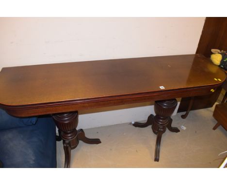 A Regency style mahogany console table, with neo classical style turned supports, raised on splayed feet, 160.5cms wide.
