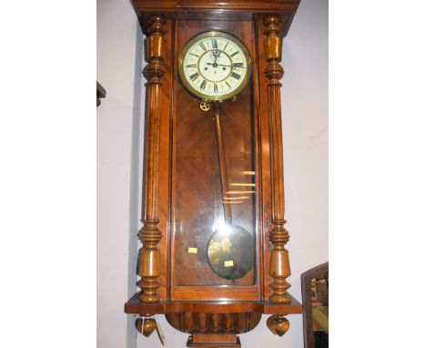 A Vienna wall clock by Gustav Becker, enamel roman dial, in walnut case.