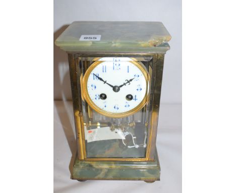A French late 19th Century giltmetal and onyx four-glass mantel clock, with enamelled arabic dial, French style drum movement