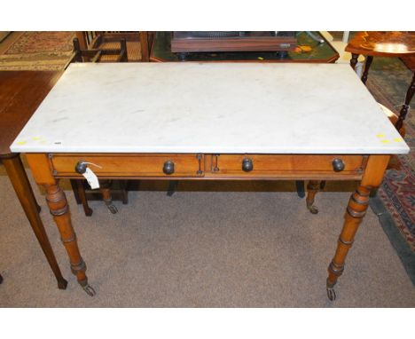 A late 19th Century ash wash stand by Heals, the marble top above carved and inlaid frieze drawers, raised on turned feet ter