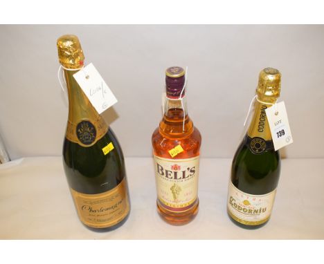a 1 ltr. bottle of Bells Blended Scotch Whisky; a 1.5 ltr. bottle of Demi Sec Charlemagne Premium Champagne; and a 75cl. bott