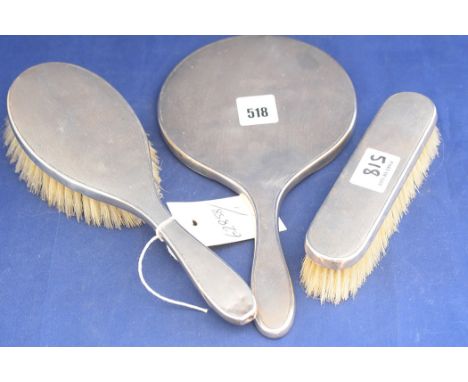 An Elizabeth II silver dressing table set, by Padgett & Braham Ltd., London 1952, comprising: hand mirror, hair brush and clo