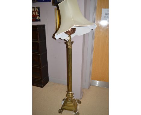 A Victorian brass and copper extendable standard lamp, with corinthian style column, converted to electricity.