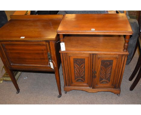 An early 20th Century walnut side cabinet, with carved panel cupboard doors opening to reveal shelving, terminating in cerami