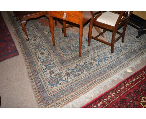 A North West Persian carpet, the central diamond-shaped medallion on red ground, decorated with foliate scrolls and matching 