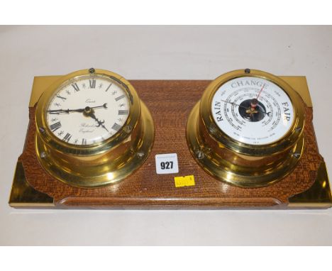 A quartz clock and barometer, mounted on an oak board.