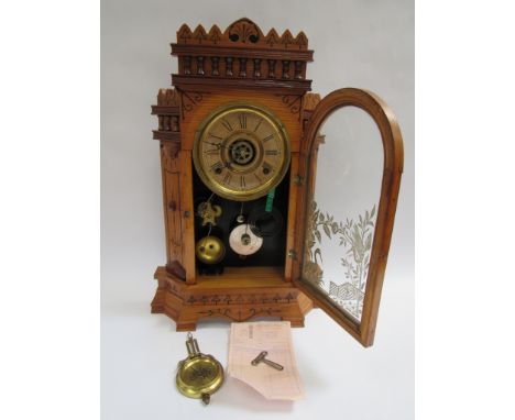 An early 20th Century 'Gilbert Altai' oak gingerbread style mantel clock with strike and alarm works, key, pendulum and recei