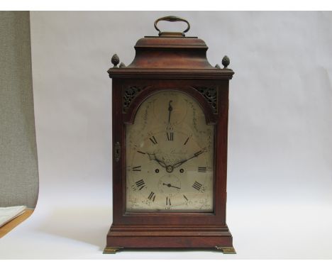 A George III mahogany bracket clock with bell top, the silvered brolan arched dial with calendar and strike/silent subsidiary