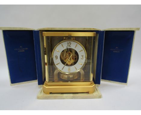A Jaeger LeCoultre Atmos clock, no. 277969, in gilt brass and glazed casing, LeCoultre caliber 528-8, 23.2cm high, together w