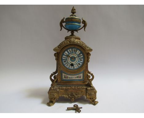 A mid to late 19th Century French ormolu timepiece with rococo motifs, hand painted and gilt porcelain dial (slightly offset)