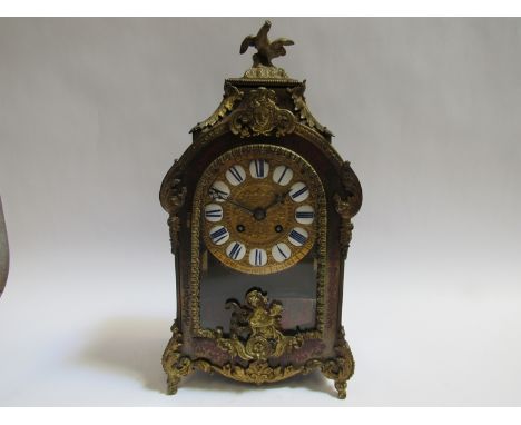 A 19th Century French boulle work mantel clock with decorative ormolu mounts, feet and finial, gilt brass repousse dial with 