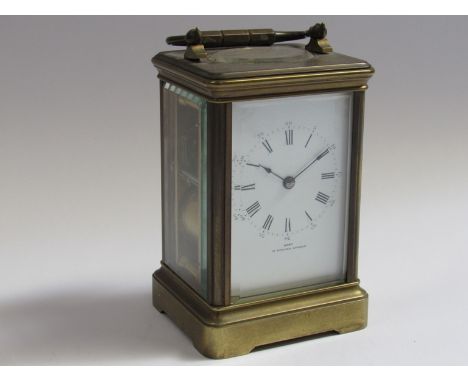 A late 19th Century brass cased striking carriage clock, Roman enamelled dial signed Dent, 61 Strand, London, 8 day movement 