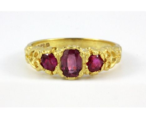 A 9ct yellow gold three ruby set ring, (O).