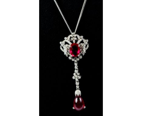 An 18ct white gold pendant and chain set with diamonds and oval and cabochon cut rubies, ruby weight over 5 carat, L. 6cm.