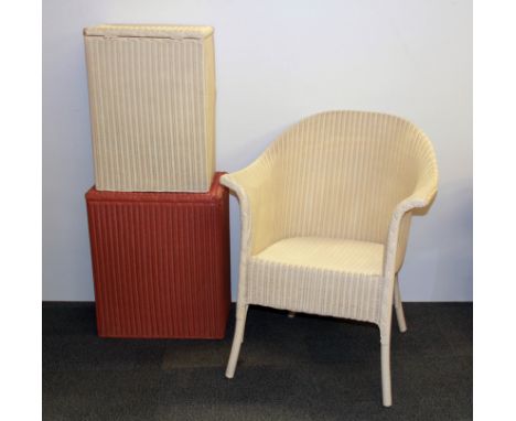 A Lloyd loom chair and two linen baskets.