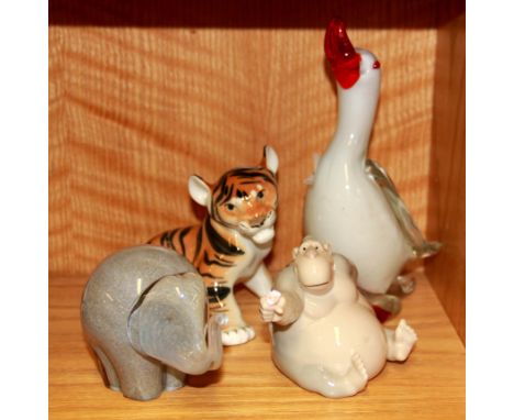 A Murano style glass duck, a Wedgwood elephant, a Russian porcelain tiger and a Nao monkey.