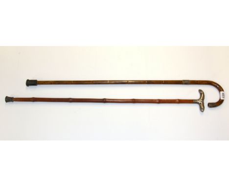 A hallmarked silver handled saddle walking stick and a further walking stick.