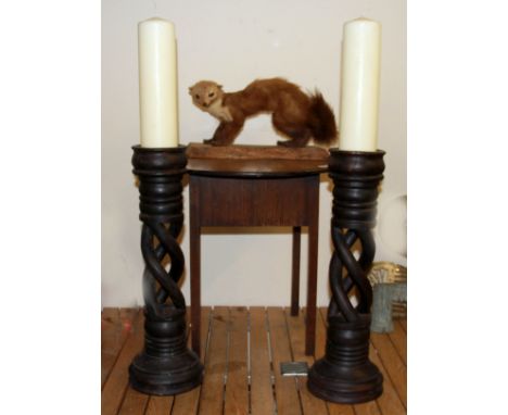 A pair of carved wooden candle stands, a vintage workbox and a taxidermy animal.