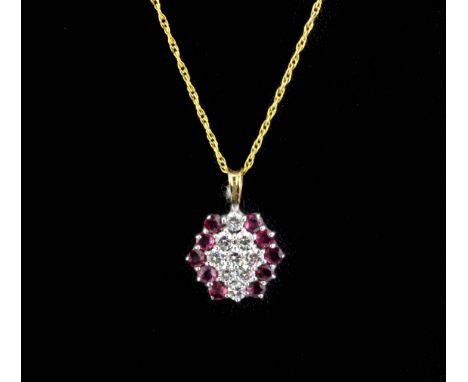 A 9ct yellow gold ruby and white stone set pendant and chain.