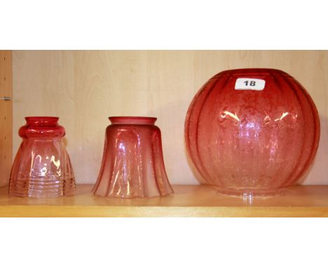 Three Victorian cranberry glass lamp shades two with acid etched detail, H. 17cm.