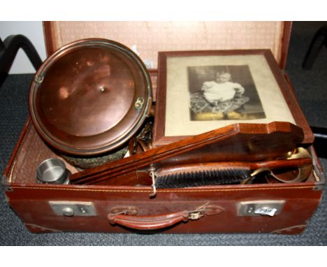 A vintage suitcase and contents.