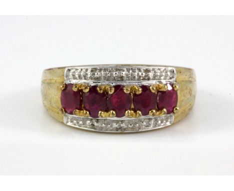 A 9ct yellow gold ruby and diamond set ring, (L.5).