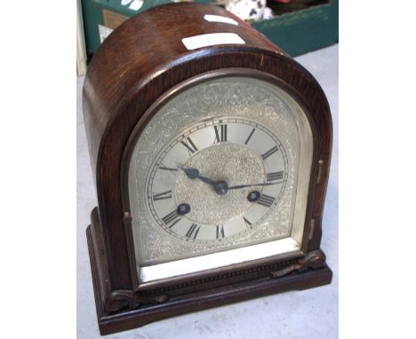 An early 20th century oak cased eight day mantel clock, silvered dial with Roman numerals inscribed "Felix Martin, Swansea", 