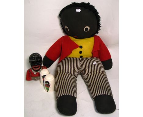 A large golly doll, height 80cm (af), a set of ceramic golly salt and pepper shakers and a similar money box (4).