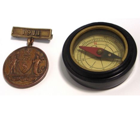 A 1911 Liverpool Civil Service League medal and a small bakelite style cased compass (2).