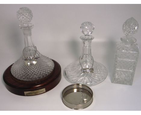 Three cut glass and crystal decanters, one with a silver label "Whiskey" marked sterling, one with a hallmarked silver label 