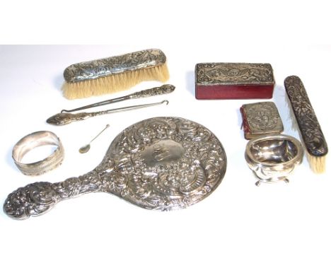 A silver handle hand mirror and two clothes brushes, a silver bangle, a miniature bible with a silver cover, a leather box wi