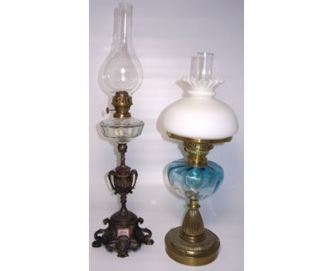 A Victorian brass oil lamp with opaque shade, clear blue glass reservoir and with fluted support and a spelter example with c