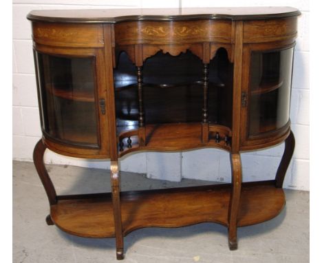 An Edwardian mahogany and inlaid display cabinet with galleried central section flanked by two glazed doors each with one int