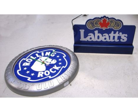 A late 20th century circular wall clock for "Rolling Rock" extra pale premium beer and an illuminated counter top "Labatts" b