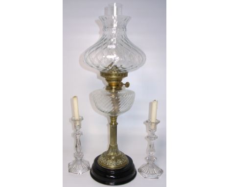 A Victorian brass oil lamp with attractive clear glass reservoir, fluted column style support on ebonised base, height 66cm a