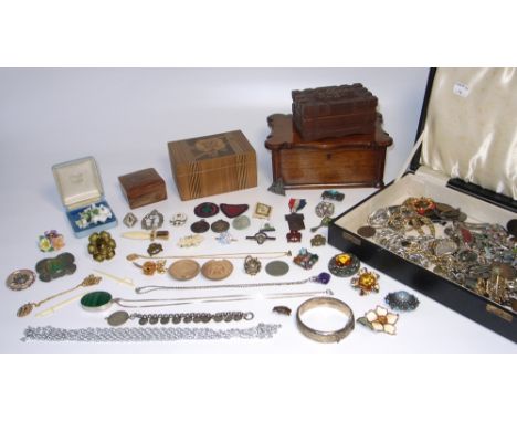 A quantity of costume jewellery to include brooches and necklaces, some silver, a quantity of medals and badges to include so