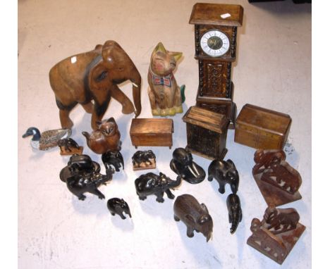 A box containing a quantity of mainly treen items to include ebonised elephants, elephant bookends, money boxes, a large carv