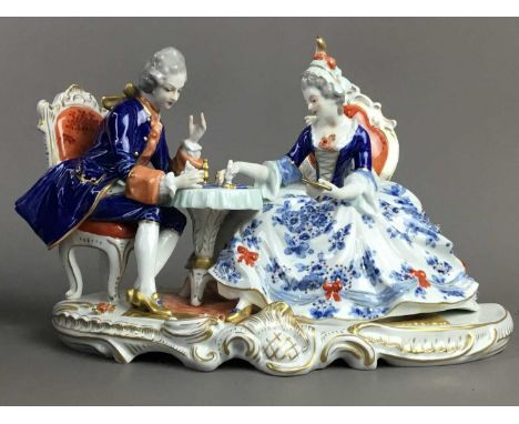 CONTINENTAL FIGURE GROUP,of a seated male and female, 16cm high, along with a Royal Stratford figure of a fox, number 702/250
