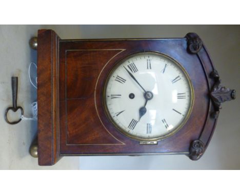 An early 19thC brass string inlaid mahogany cased bracket timepiece, the low, round arched top with carved and applied foliat