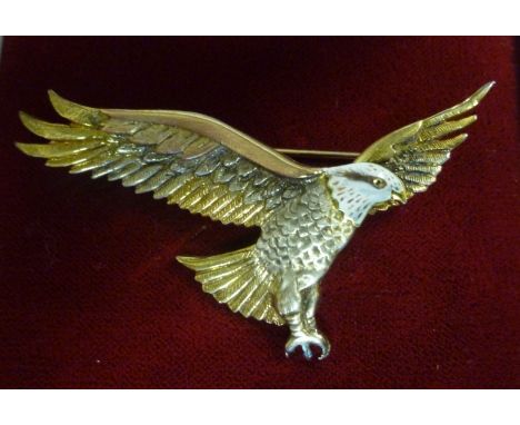 A 9ct bi-coloured gold and coloured enamel spreadeagle brooch