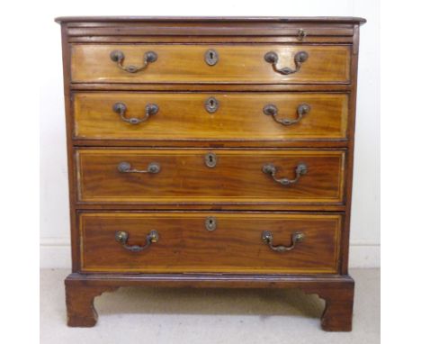 An early 19thC satinwood string inlaid mahogany dressing chest, the top having a fan marquetry motif and a thumb moulded edge