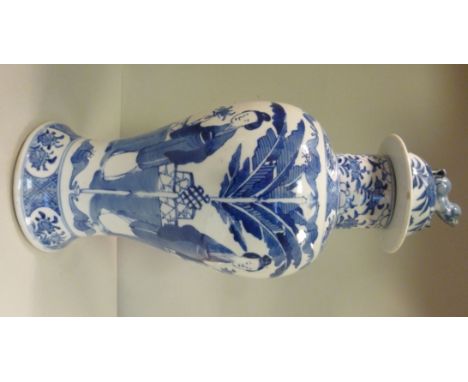 A late 19thC Chinese porcelain temple vase of baluster form, a mythical dog on the domed cover, decorated in blue and white w