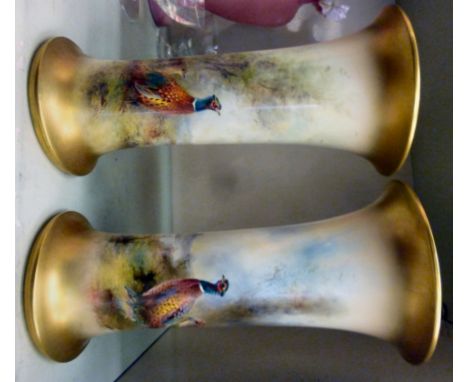 A matched pair of Jas Stinton Royal Worcester porcelain vases of cylindrical form, each having a flared rim, on a splayed foo
