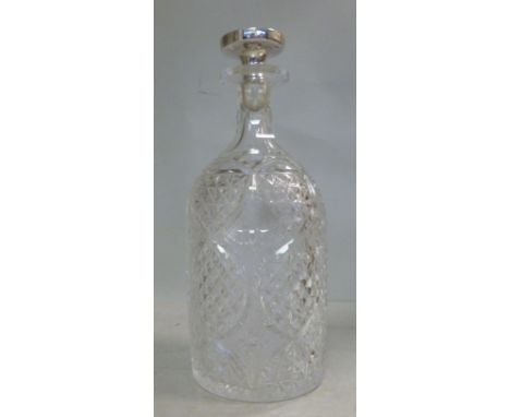 An Edwardian glass decanter of cylindrical form, having a tapered neck and flange lip, decorated with slice and hobnail cut d