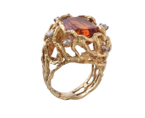 A 1970s citrine and diamond dress ring, the cushion cut citrine within an openwork branch like surround, set with brilliant c