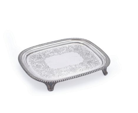 A late George III silver oblong salver by William Bennett, London 1818, with a raised gadrooned rim, engraved with a broad ba