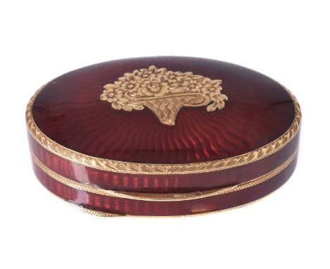 A red guilloche enamel oval pill box, the hinged cover applied with a basket of flowers plaque, stamped 750, 5cm long, 35.4g 