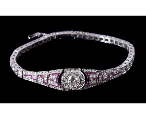 An early 20th century diamond and ruby bracelet, circa 1910, the central old brilliant cut diamond, estimated to weigh 0.80 c