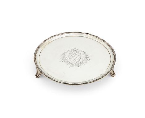 A George III silver circular salver by Robert Jones I, London 1782, with a beaded rim, on three bead outlined bracket feet, e