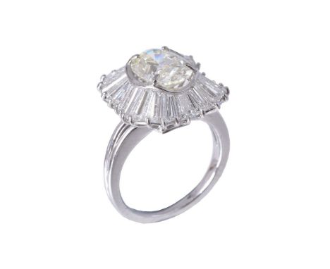 A diamond ballerina dress ring, the central oval cut diamond, weighing 2.33 carats, claw set within a surround of tapered bag